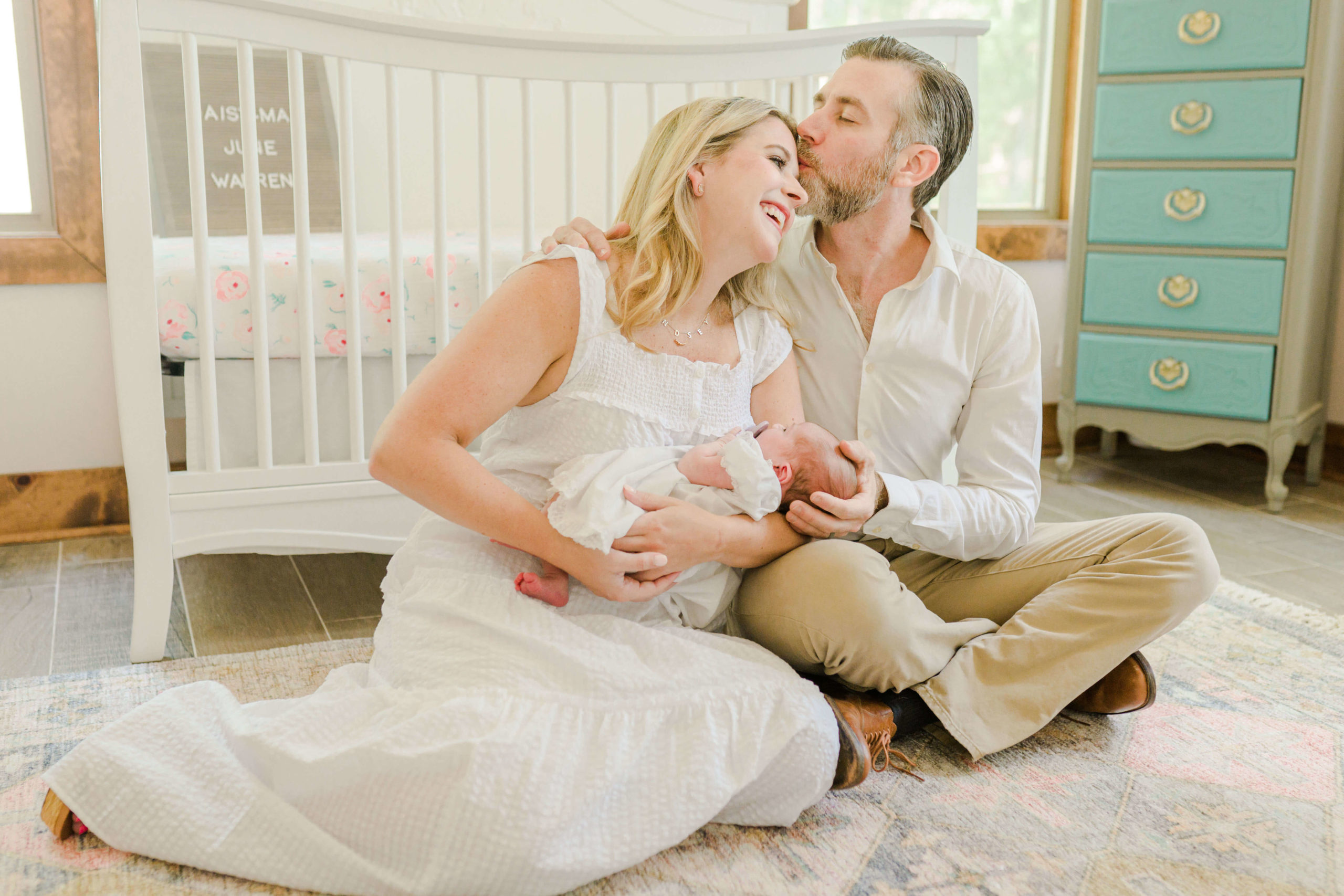 Dad kissing mom on forehead during lifestyle session