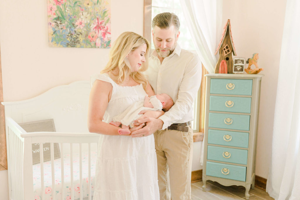 Mom, dad and baby in nursing during lifestyle session