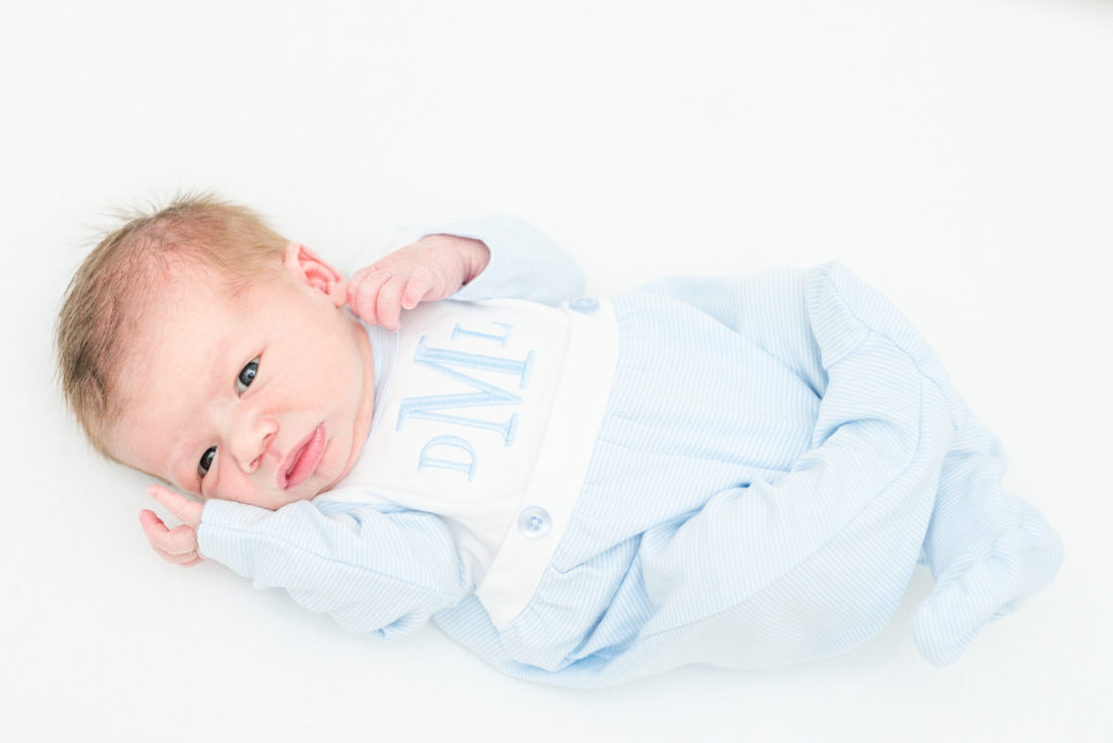 Full picture of baby laying in crib