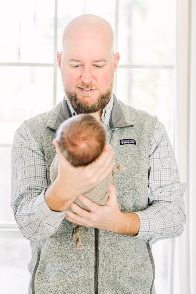 Dad looking at baby