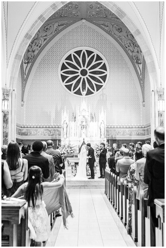 Anna and John Parker during their wedding ceremony inside the Cathedral of St. Peter the Apostle in Jackson, Mississippi.